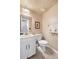 Cozy powder room featuring a white vanity, toilet, and neutral wall paint at 7355 S Knolls Way, Centennial, CO 80122