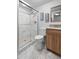 Contemporary bathroom features a glass-enclosed shower, wooden vanity, and sleek fixtures for a spa-like experience at 7355 S Knolls Way, Centennial, CO 80122