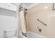 This bathroom includes a shower/tub combo with a shower curtain and a convenient grab bar at 7355 S Knolls Way, Centennial, CO 80122