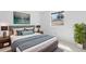 Bedroom featuring a queen-sized bed, stylish lamps, and a lovely plant in the corner at 7355 S Knolls Way, Centennial, CO 80122