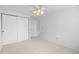 Simple bedroom with a ceiling fan and ample closet space, offering a blank canvas at 7355 S Knolls Way, Centennial, CO 80122