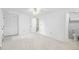 Spacious bedroom with light carpet, ceiling fan, and a view of the ensuite bath at 7355 S Knolls Way, Centennial, CO 80122