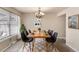Elegant dining room with modern chairs, wooden table and decorative rug at 7355 S Knolls Way, Centennial, CO 80122