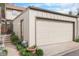 Attached garage with side access door, surrounded by easy to maintain landscaping at 7355 S Knolls Way, Centennial, CO 80122