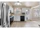 Well-lit kitchen with modern stainless steel appliances and white cabinets at 7355 S Knolls Way, Centennial, CO 80122