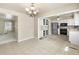 Bright open kitchen connected to dining area with stainless steel appliances and tile floor at 7355 S Knolls Way, Centennial, CO 80122