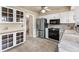 Bright kitchen featuring stainless steel appliances, white cabinetry, and tiled flooring at 7355 S Knolls Way, Centennial, CO 80122