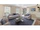Bright and airy living room featuring neutral tones, a comfortable sofa, and stylish decor at 7355 S Knolls Way, Centennial, CO 80122