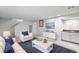 Inviting living room boasts modern furniture, a flat-screen TV, and a wet bar, ideal for entertaining at 7355 S Knolls Way, Centennial, CO 80122