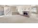 Spacious living room with a brick fireplace, staircase and neutral carpet at 7355 S Knolls Way, Centennial, CO 80122