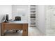 Comfortable office space with desk, built-in shelving, and natural light creates an ideal work-from-home setting at 7355 S Knolls Way, Centennial, CO 80122