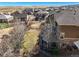 An aerial view of a brown home showing the deck and grassy yard and views to surrounding neighborhood at 7680 S Blackstone Pkwy, Aurora, CO 80016