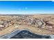 An overhead shot showing the neighborhood, a pond, open land, and community at 7680 S Blackstone Pkwy, Aurora, CO 80016