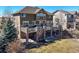 Exterior view of backyard with deck, stone pillars and landscaping at 7680 S Blackstone Pkwy, Aurora, CO 80016
