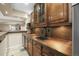 Basement bar features a wooden counter and wood cabinets with tiled backsplash at 7680 S Blackstone Pkwy, Aurora, CO 80016