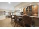 Basement bar showcasing wood cabinetry, sink and pendant lighting at 7680 S Blackstone Pkwy, Aurora, CO 80016