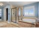 Bathroom featuring a walk-in shower and soaking tub at 7680 S Blackstone Pkwy, Aurora, CO 80016