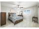 Bedroom featuring a wooden bed frame, neutral carpet, and sunny window at 7680 S Blackstone Pkwy, Aurora, CO 80016
