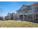 Beautiful multi-level deck featured on this brown two-story house with stone accents at 7680 S Blackstone Pkwy, Aurora, CO 80016