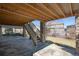 Outdoor patio area with stone pillars and stairs leading to the upper deck at 7680 S Blackstone Pkwy, Aurora, CO 80016