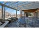 Covered patio with a stone surround, outdoor seating and string lights at 7680 S Blackstone Pkwy, Aurora, CO 80016