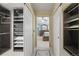Walk-in closet with built in shelving units at 7680 S Blackstone Pkwy, Aurora, CO 80016