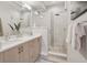 Bright bathroom featuring a double vanity and a glass-enclosed shower with a rainfall showerhead at 1836 Grove St # 108, Denver, CO 80204
