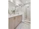 Bright bathroom featuring a double vanity and a glass-enclosed shower with a rainfall showerhead at 1836 Grove St # 108, Denver, CO 80204