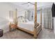 Spacious bedroom with a four-poster bed and ample natural light at 1836 Grove St # 108, Denver, CO 80204