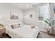 Cozy bedroom with neutral decor, a comfortable bed, and natural light at 1836 Grove St # 108, Denver, CO 80204