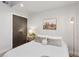 Cozy bedroom featuring a queen bed, stylish decor, and ample natural light at 1836 Grove St # 108, Denver, CO 80204
