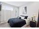 Cozy bedroom with a plush bed, modern decor, and natural light from the window at 1836 Grove St # 108, Denver, CO 80204