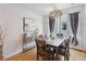 Well-lit dining room with modern lighting, stylish decor, and window view at 1836 Grove St # 108, Denver, CO 80204