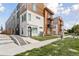 Modern townhome with mixed material facade, including concrete, wood, and metal accents at 1836 Grove St # 108, Denver, CO 80204