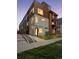 Modern townhome with mixed material facade, including concrete, wood, and metal accents at 1836 Grove St # 108, Denver, CO 80204