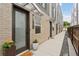 Inviting front door with brick facade, potted plants, and a welcome mat at 1836 Grove St # 108, Denver, CO 80204