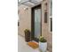 Charming front door with brick accents and colorful flower planters that welcome you home at 1836 Grove St # 108, Denver, CO 80204