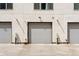 Exterior view of garage showing doors, security cameras and lighting at 1836 Grove St # 108, Denver, CO 80204
