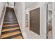 Hallway with a staircase, tile floor, and access to a bathroom at 1836 Grove St # 108, Denver, CO 80204