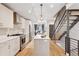 Bright kitchen with stainless appliances, center island and open access to the staircase at 1836 Grove St # 108, Denver, CO 80204