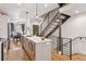 Bright, open kitchen with stainless steel appliances, an island, and modern lighting fixtures at 1836 Grove St # 108, Denver, CO 80204