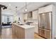 Modern kitchen featuring stainless steel appliances, ample counter space, and open layout to the living room at 1836 Grove St # 108, Denver, CO 80204