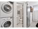 Convenient laundry area with a washer and dryer next to a bathroom at 1836 Grove St # 108, Denver, CO 80204