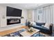 Bright living room featuring a fireplace, flat screen tv, and blue couches at 1836 Grove St # 108, Denver, CO 80204