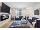 Bright living room featuring a fireplace, flat screen tv, and blue couches at 1836 Grove St # 108, Denver, CO 80204