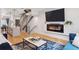 Open living room with a fireplace, TV, and staircase at 1836 Grove St # 108, Denver, CO 80204