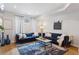Bright living room featuring a fireplace, flat screen tv, and blue couches at 1836 Grove St # 108, Denver, CO 80204