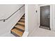 Modern staircase with wood treads and a sleek metal railing at 1836 Grove St # 108, Denver, CO 80204