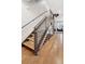 Contemporary staircase with metal railings and hardwood floors at 1836 Grove St # 108, Denver, CO 80204