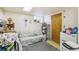 Bedroom featuring a small bed, rug, and various belongings, including a mini fridge at 1850 S Williams St, Denver, CO 80210